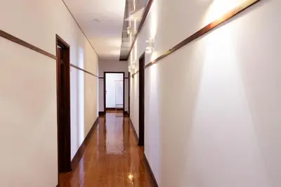 a hallway with white walls and wooden floors at Fradelos Porto Centro in Porto