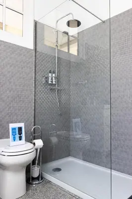 a bathroom with a toilet and a glass shower at Fradelos Porto Centro in Porto