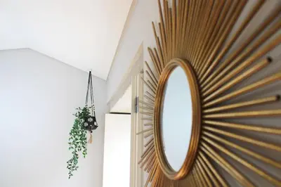 a mirror is on the wall of a room at Virtudes Irresistible Getaway in Porto