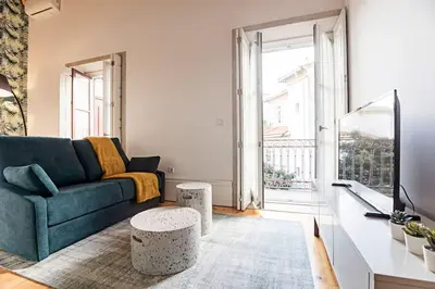 a living room with a couch and a table at Oporto Colorful Flat in Porto