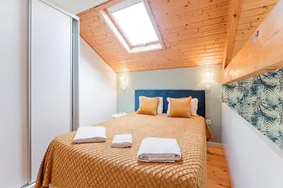 a bedroom with a bed with two towels on it at Oporto Colorful Flat in Porto