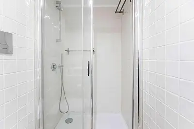 a bathroom with a shower with a glass door at Oporto Colorful Flat in Porto