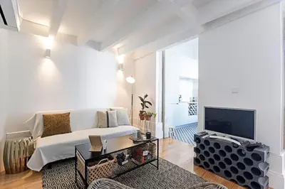 a living room with a couch and a tv at O Aleph, irresistible duplex apt. w/AC and balcony in Porto