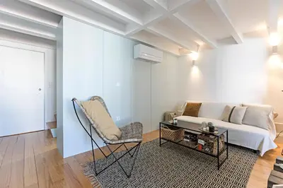 a living room with a couch and a table at O Aleph, irresistible duplex apt. w/AC and balcony in Porto