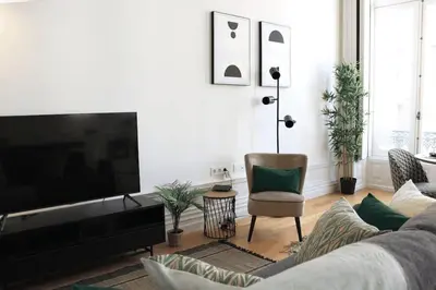 a living room with a couch and a flat screen tv at Luxury Porto Unique in Porto