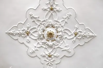 a silver snowflake ornament on a white wall at Luxury Porto Unique in Porto