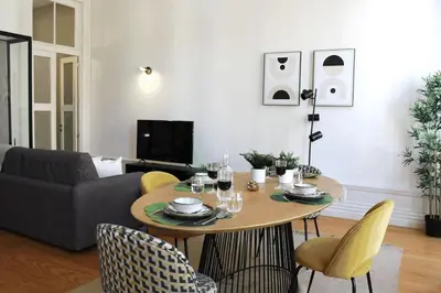 a living room with a table and yellow chairs at Luxury Porto Unique in Porto