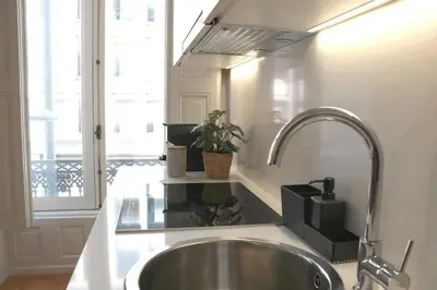 a kitchen counter with a sink and a window at Luxury Porto Unique in Porto