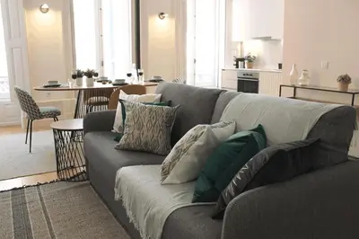 a living room with a gray couch with pillows at Luxury Porto Unique in Porto