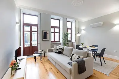 a living room with a couch and a table at Historical Sunny Marquês - With AC! in Porto
