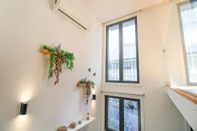 a hallway with windows and plants on the wall at Porto Trindade Triplex in Porto