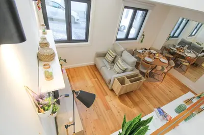 a living room with a couch and a table at Porto Trindade Triplex in Porto