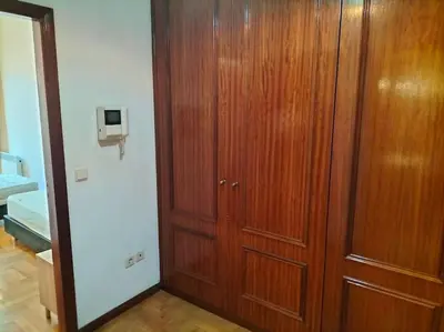 a wooden closet with a wooden door in a room at Flores Apartment in Porto