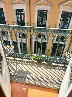 a balcony with a fence in front of a building at Flores Apartment in Porto