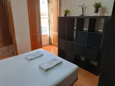 a room with a bed with two utensils on it at Flores Apartment in Porto