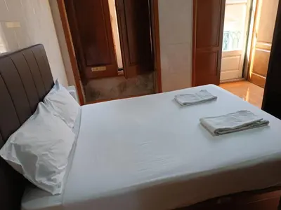 a bed with two utensils sitting on top of it at Flores Apartment in Porto