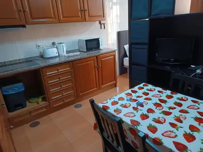 a kitchen with a table with a flower pattern on it at Flores Apartment in Porto