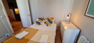 a room with a bed with pillows on it at Molecular Apartment in Porto