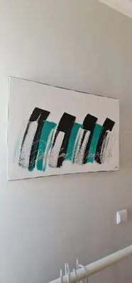 a painting hanging on a white wall at Molecular Apartment in Porto