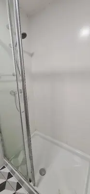 a shower with a glass door in a bathroom at Molecular Apartment in Porto