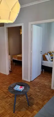 a living room with a table and a bed at Molecular Apartment in Porto