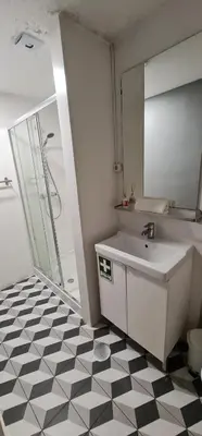 a bathroom with a white sink and a shower at Molecular Apartment in Porto
