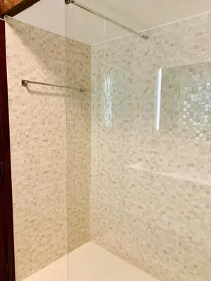 a shower with a glass door in a bathroom at Bairro das arts in Porto