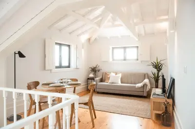 a white living room with a couch and a table at Fontainhas Douro Views by LovelyStay in Porto