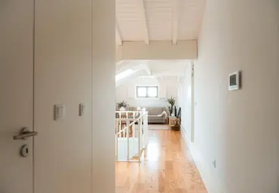 a white hallway with a living room and a couch at Fontainhas Douro Views by LovelyStay in Porto