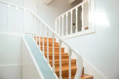 a white staircase with white railings in a house at Fontainhas Douro Views by LovelyStay in Porto