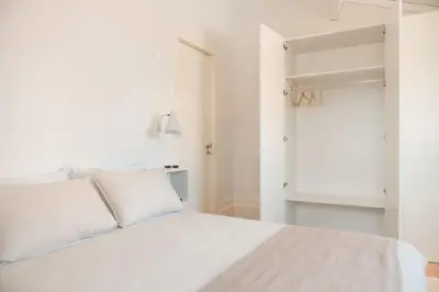 a white bed with white pillows in a bedroom at Fontainhas Douro Views by LovelyStay in Porto