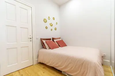 a bedroom with a bed with red pillows on it at Riverside Cozy Studio by LovelyStay in Porto