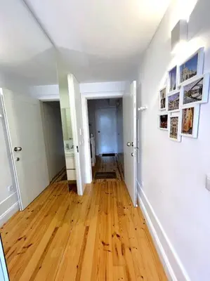 an empty hallway with a hard wood floor in an apartment at Caldeireiros Lovely Suite by Porto City Hosts in Porto