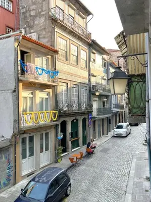 a street with buildings and a car parked on the street at Caldeireiros Lovely Suite by Porto City Hosts in Porto