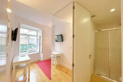 a bathroom with a shower and a sink and a mirror at Caldeireiros Lovely Suite by Porto City Hosts in Porto