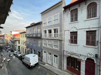 a city street with a white truck parked in front of buildings at Caldeireiros Lovely Suite by Porto City Hosts in Porto