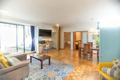 a living room with a couch and a table at Republica Square Apartment by Porto City Hosts in Porto