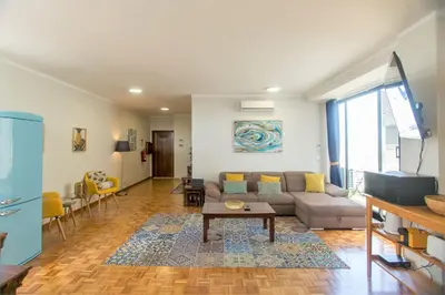 a living room with a couch and a table at Republica Square Apartment by Porto City Hosts in Porto