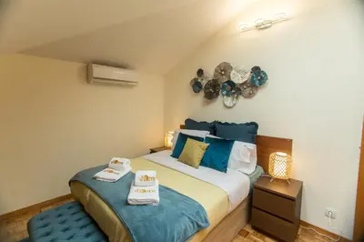 a bedroom with a bed with two towels on it at Republica Square Apartment by Porto City Hosts in Porto