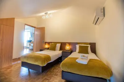 a hotel room with two beds and two lamps at Republica Square Apartment by Porto City Hosts in Porto
