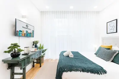 a bedroom with a bed and a desk at GuestReady - Studio in Porto in Porto