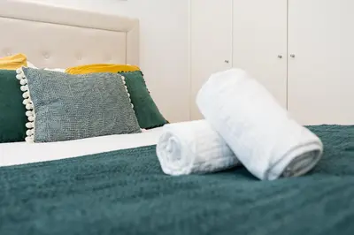 a pair of rolled towels sitting on a bed at GuestReady - Studio in Porto in Porto
