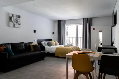 a living room with a bed and a couch at Almada Downtown 203 in Porto
