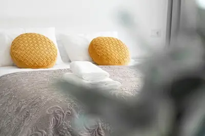 a bed with two towels and two pillows on it at Almada Downtown 301 in Porto