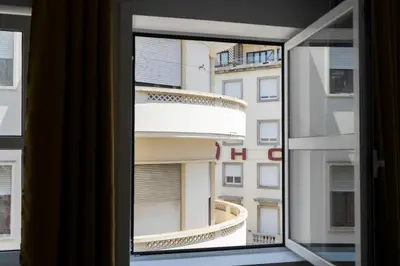 a window with a view of a building at Almada Downtown 301 in Porto