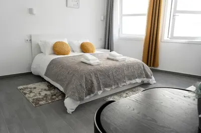 a bedroom with a bed with two towels on it at Almada Downtown 301 in Porto