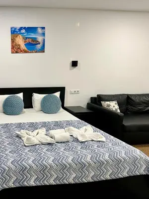 a bedroom with a bed with two pairs of shoes on it at Almada Downtown 302 in Porto