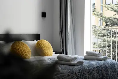 a bedroom with a bed with towels and a window at Almada Downtown 303 in Porto