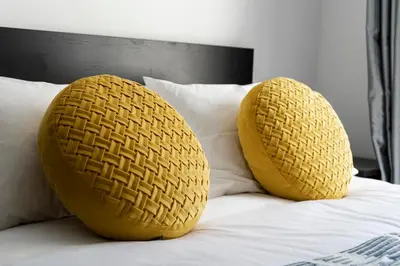 two yellow baskets on top of a bed at Almada Downtown 303 in Porto
