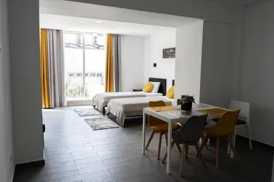a bedroom with a bed and a table and chairs at Almada Downtown 304 in Porto